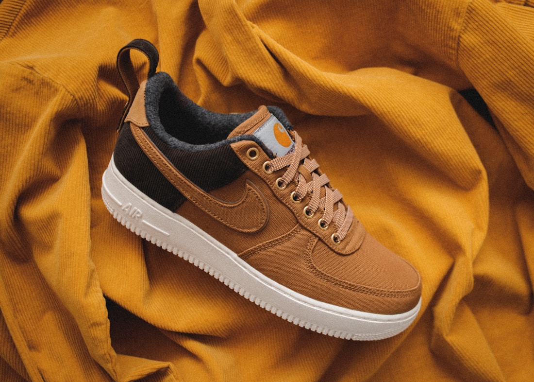 Orange casual sneakers photographed as a style illustration